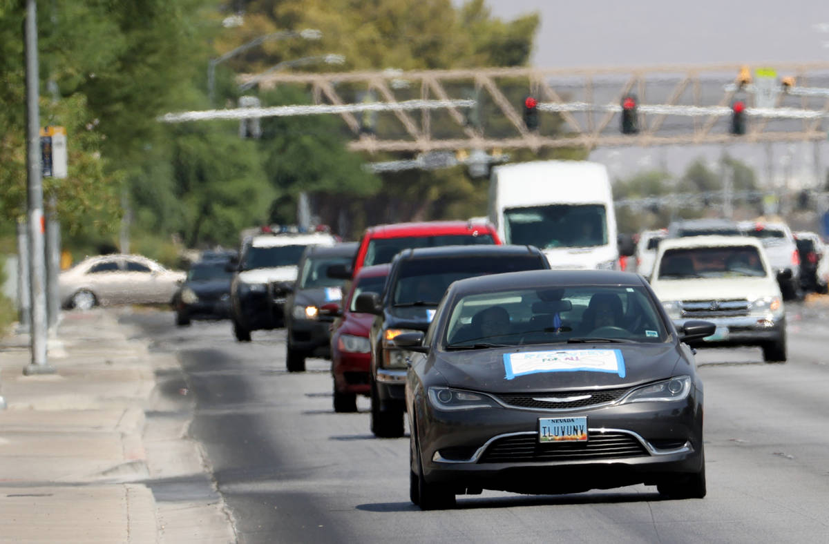 Activists during a car caravan on North Lamb Boulevard in Las Vegas to protest evictions Tuesda ...