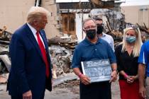 President Donald Trump talks with John Rode of Rode's Camera Shop as he speaks with business ow ...