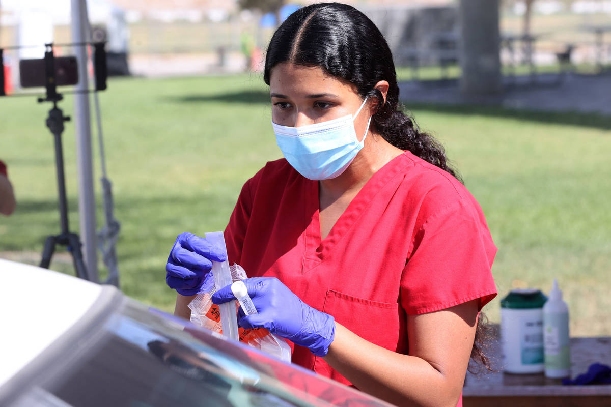 Registered nurse Liliana Sandoval explains a self-administered COVID-19 test to a patient at th ...