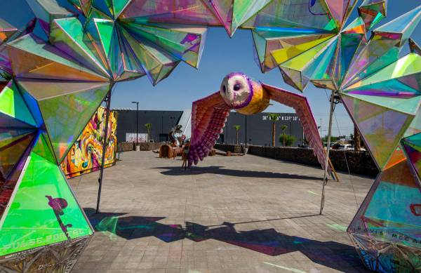 Artwork outside of Area15 is the background for a caravan including Henry Chang's art cars, an ...