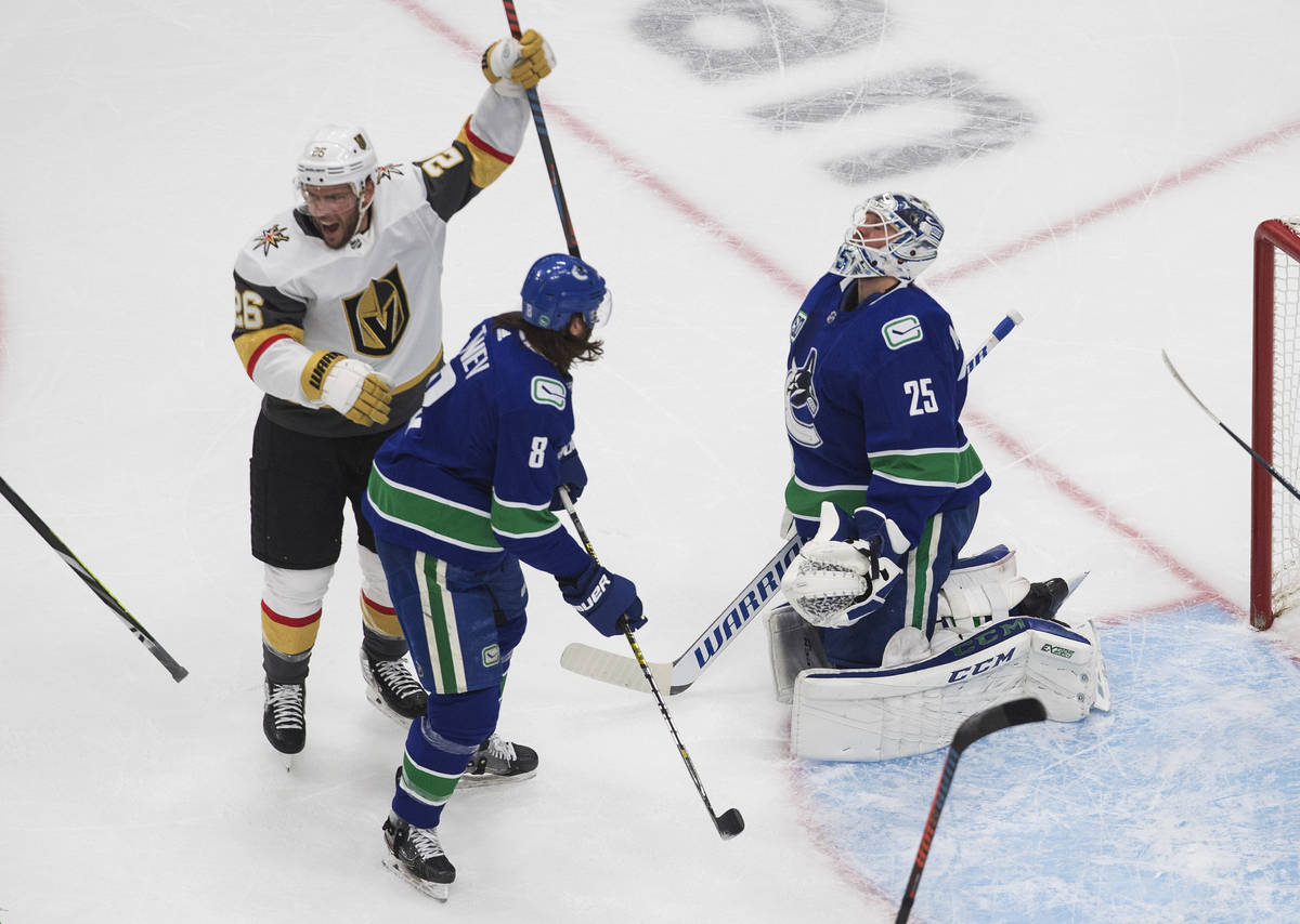 Vegas Golden Knights' Paul Stastny (26) celebrates a goal by teammate Max Pacioretty past Vanco ...