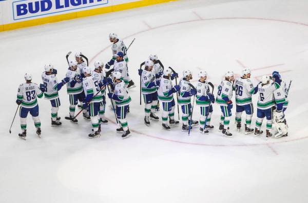 Vancouver Canucks celebrate a win over the Vegas Golden Knights during Game 5 of an NHL hockey ...