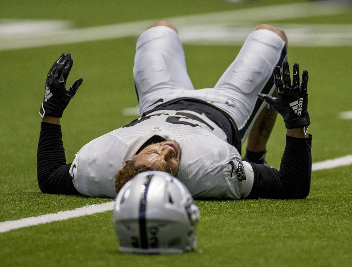 Las Vegas Raiders safety Johnathan Abram (24) stretches with teammates during warm ups at the I ...