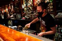 Nicky Cianella prepares drinks just before last call at The Griffin on Fremont Street in downto ...