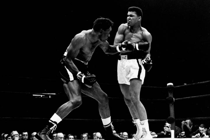 Cassius Clay exchanges punches with Charley Powell in the first round of the scheduled 10-round ...