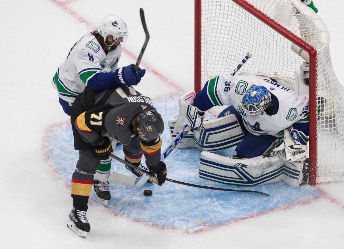 Vancouver Canucks goalie Thatcher Demko (35) makes a save on Vegas Golden Knights' William Karl ...