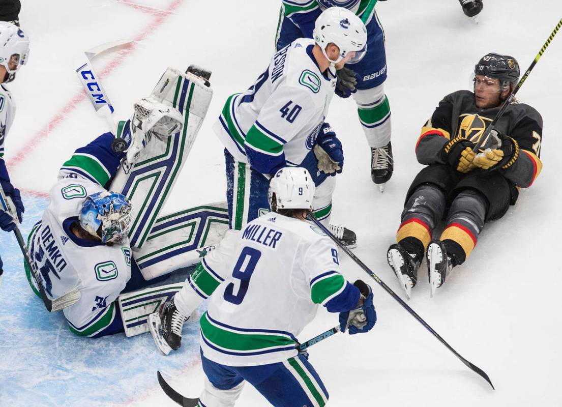 Vancouver Canucks goalie Thatcher Demko (35) makes a save as Vegas Golden Knights' William Karl ...