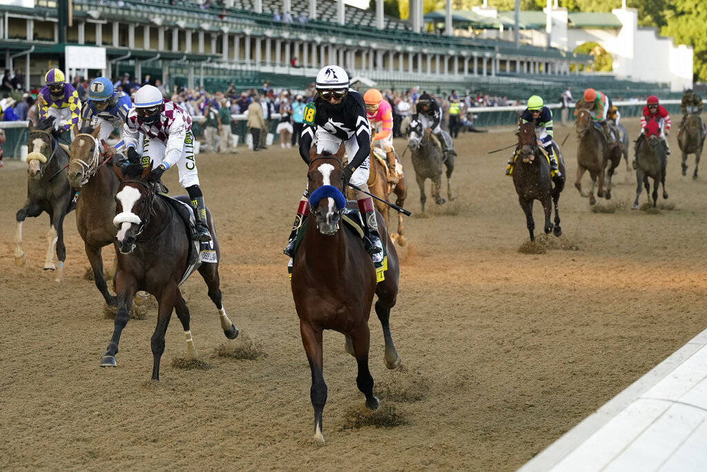 Jockey John Velazquez riding Authentic (18) crosses the finish line to win the 146th running of ...