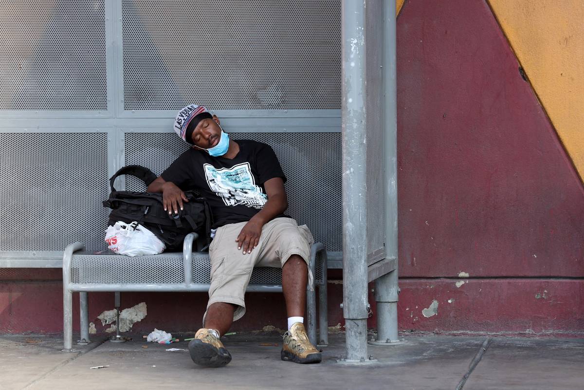 A person rests in the shade on Las Vegas Boulevard near Fremont Street Monday, Aug. 17, 2020. ( ...