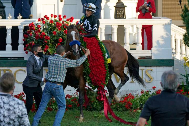 Jockey John Velazquez attempts to control Authentic in the winners' circle after winning the 14 ...