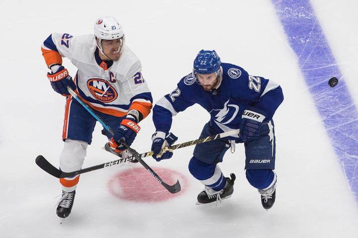 Tampa Bay Lightning's Kevin Shattenkirk (22) and New York Islanders' Anders Lee (27) battle for ...
