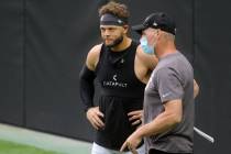 Las Vegas Raiders safety Erik Harris, left, speaks to general manager Mike Mayock during a team ...