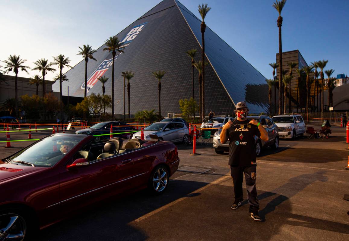 Las Vegas Aces fan Marco Benvenuti, of Las Vegas, flashes his Aces and Knights gear during a dr ...