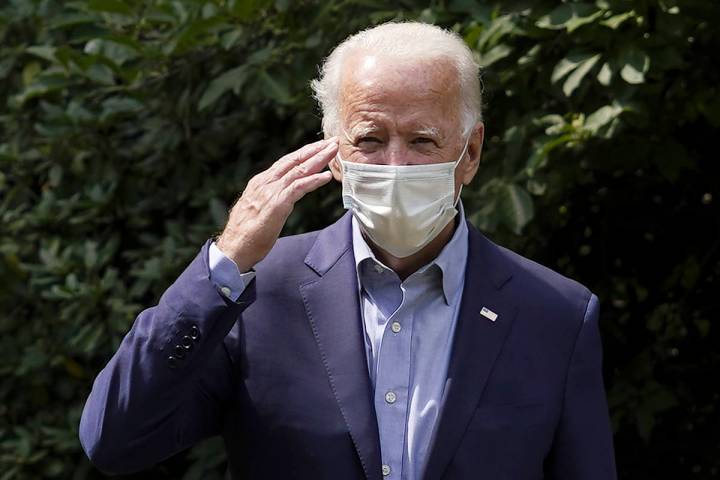 Democratic presidential candidate former Vice President Joe Biden salutes as he arrives for an ...