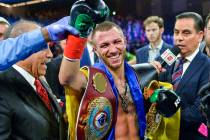 Vasiliy Lomachenko smiles after defeating Jose Pedraza in a WBO title lightweight boxing match ...