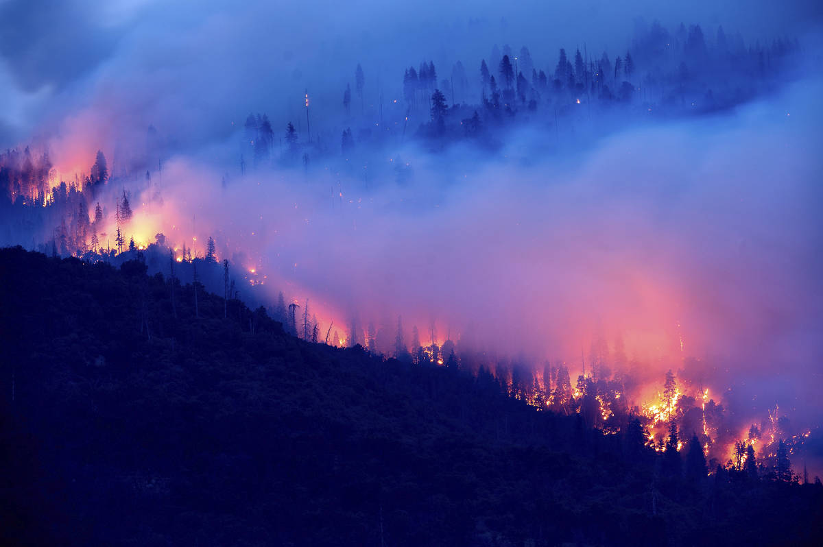 The Creek Fire burns along a hillside in the Cascadel Woods community of Madera County, Calif., ...