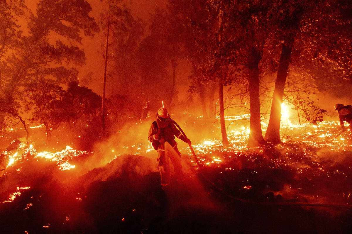 A firefighter battles the Creek Fire as it threatens homes in the Cascadel Woods neighborhood o ...