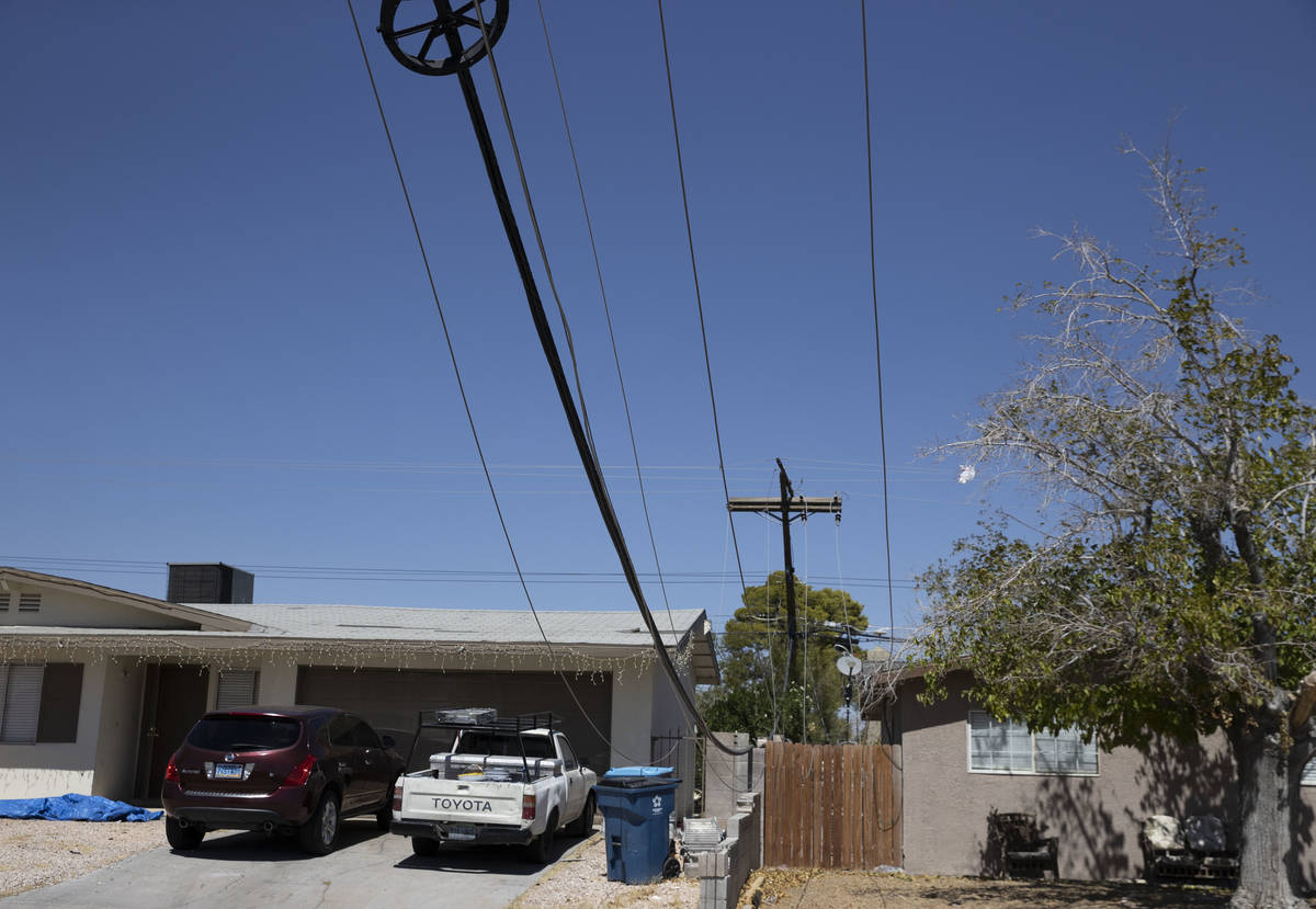 NV Energy workers repair power line knocked down by high wind causing a house water heater to e ...