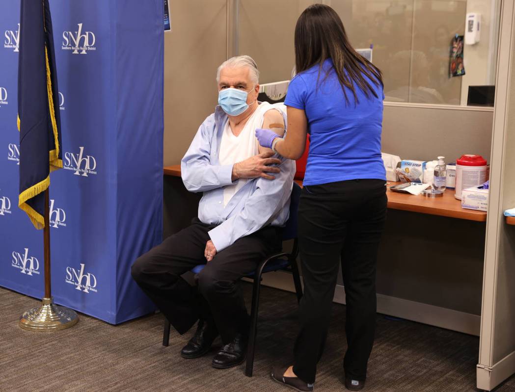 Gov. Steve Sisolak gets a flu shot from registered nurse Community Health Nurse Supervisor Mee ...