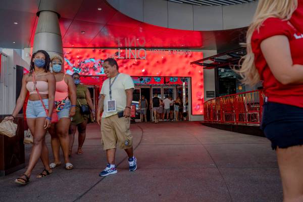 Individuals enter and exit the LINQ Hotel and Casino on the Strip on Friday, Aug. 7, 2020, in L ...