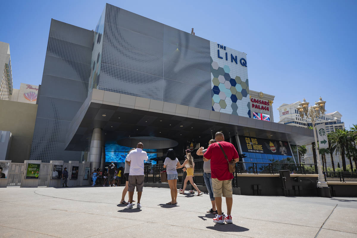 Individuals walk near the LINQ Hotel and Casino on the Strip on Friday, Aug. 7, 2020, in Las Ve ...
