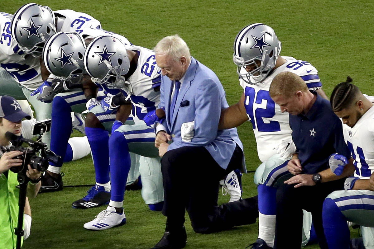 In this Monday, Sept. 25, 2017, file photo, the Dallas Cowboys, led by owner Jerry Jones, cente ...