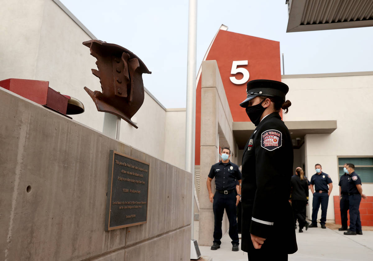 Las Vegas firefighter Lisa Leonard takes a moment with a piece of New York's World Trade Center ...