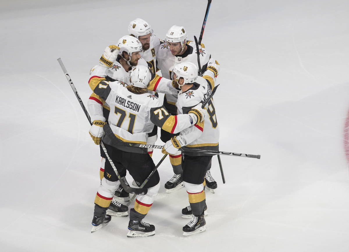 Vegas Golden Knights' Shea Theodore (27) celebrates his goal against the Dallas Stars with team ...