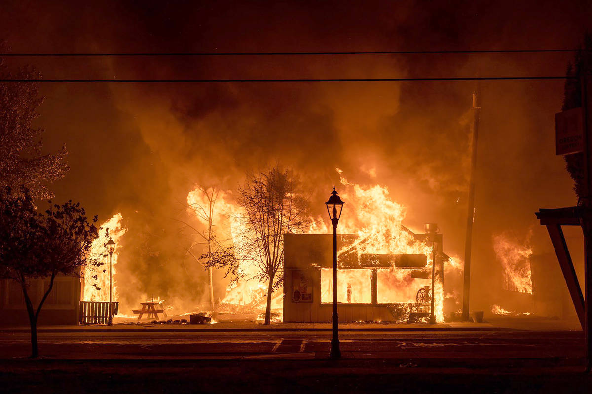 Buildings are engulfed in flames as a wildfire ravages the central Oregon town of Talent near M ...