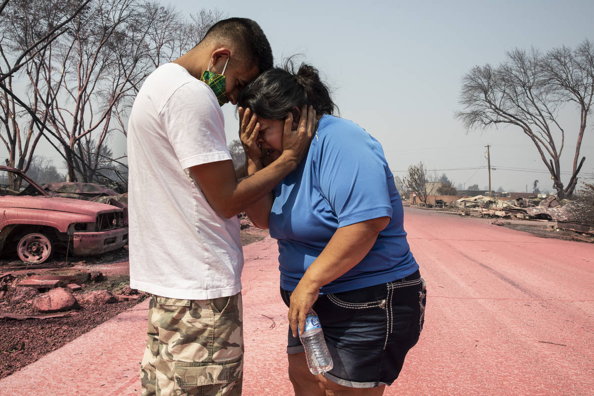 Dora Negrete is consoled consoled by her son Hector Rocha after seeing their destroyed mobile h ...