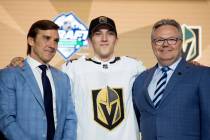 Vegas Golden Knights pick Peyton Krebs, center, poses during the first round of the NHL hockey ...