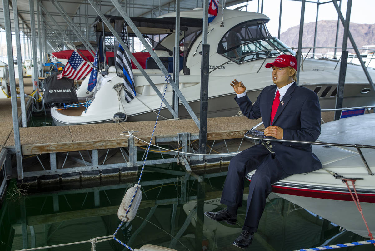 A President Donald Trump mannequin sits on the bow of a boat with others in preparation for the ...