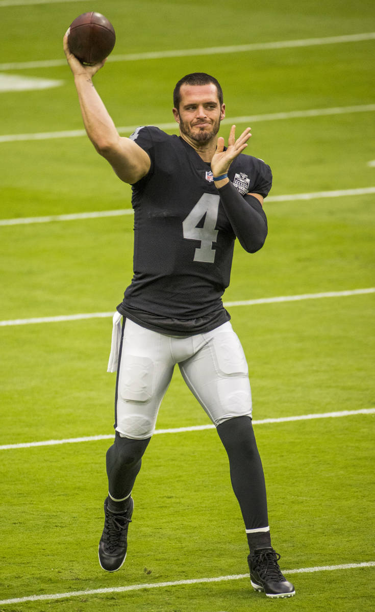 Las Vegas Raiders QB Derek Carr (4) fires a pass downfield during warm ups for a scrimmage at A ...