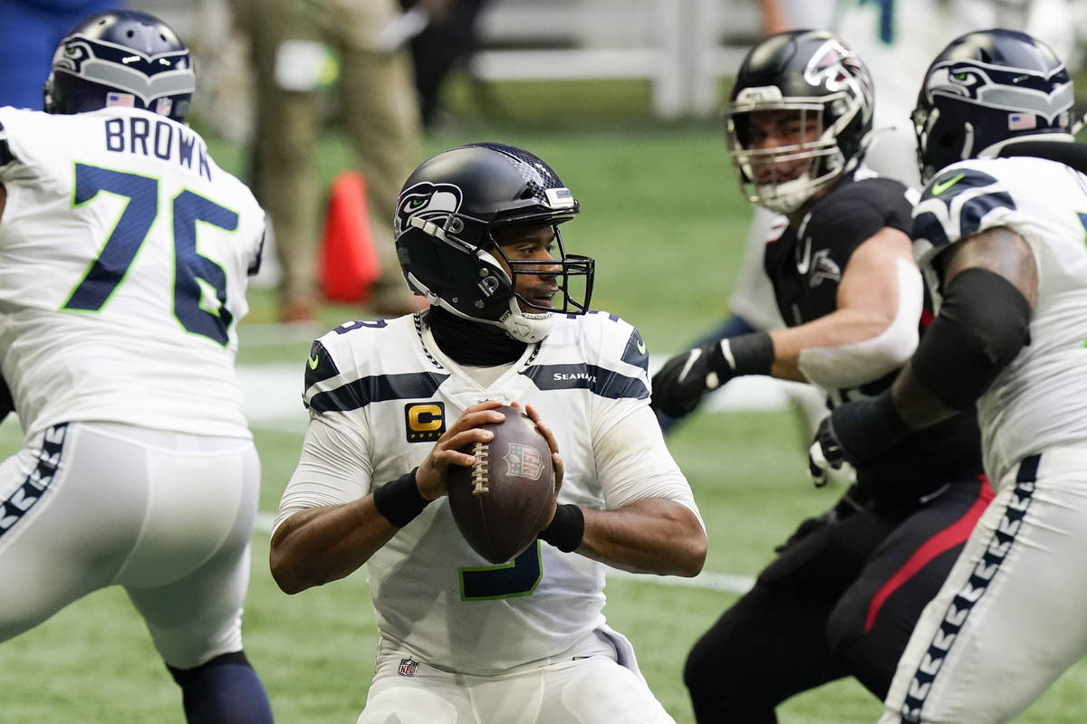 Seattle Seahawks quarterback Russell Wilson (3) works in the pocket against the Atlanta Falcons ...