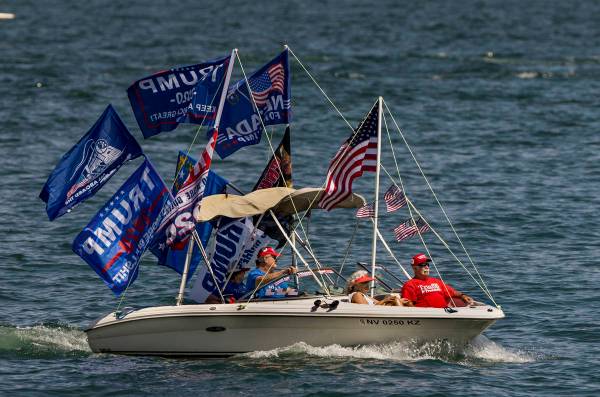 A boat is decked out with numerous flags as participants ride during the President Donald Trump ...