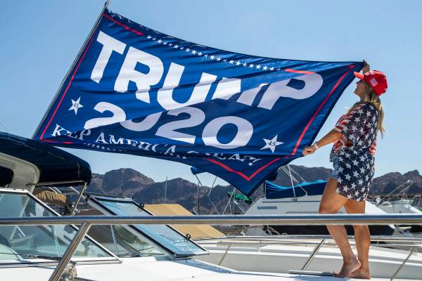 Event organizer Christine Snedden unfurls a flag as she and others prepare their boat for the P ...