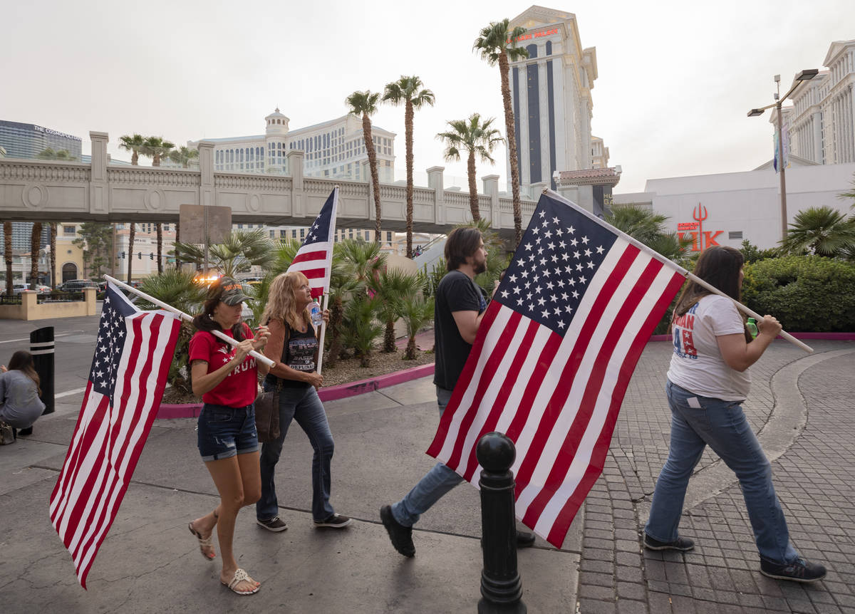 Individuals walk down the Las Vegas Strip rallying for Make Nevada Red, and Fight for Nevada, o ...