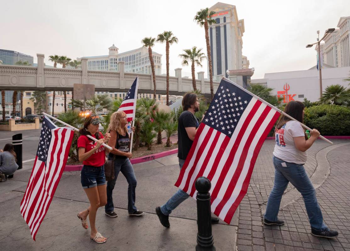 Individuals walk down the Las Vegas Strip rallying for Make Nevada Red, and Fight for Nevada, o ...