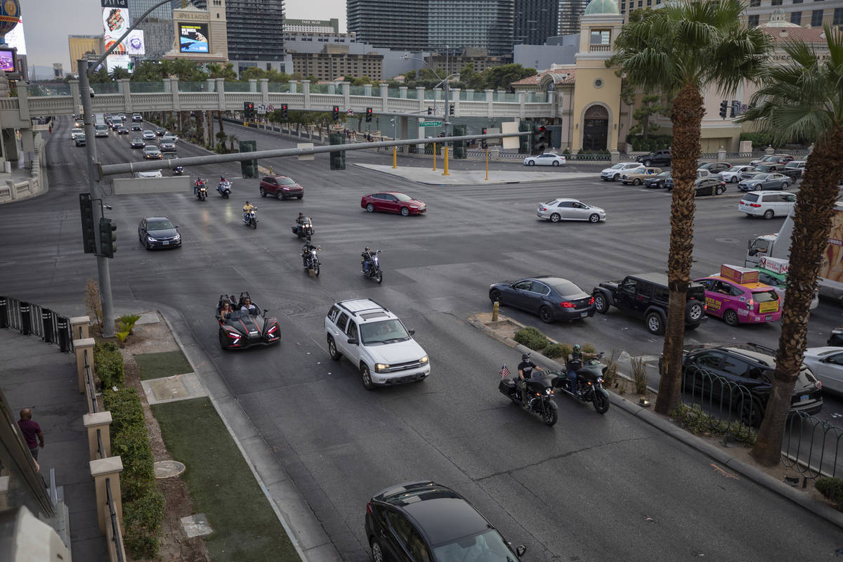 A caravan of motorcycles with American flags are seen driving down the Las Vegas Strip on Frida ...