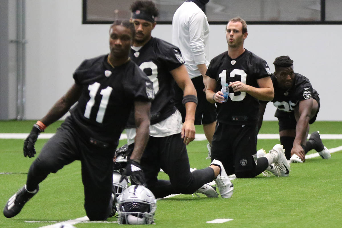 Las Vegas Raiders wide receiver Hunter Renfrow (13) stretches alongside wide receivers Henry Ru ...