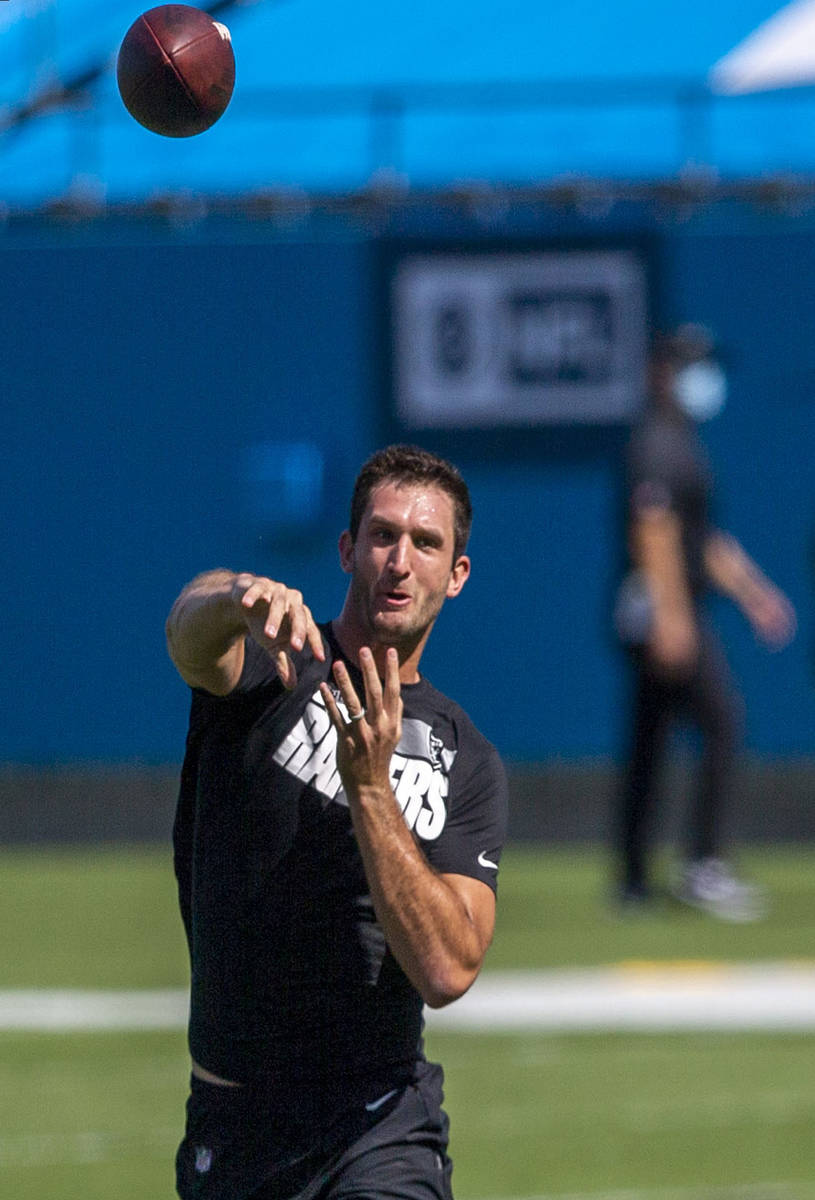 Las Vegas Raiders quarterback Nathan Peterman throws the football before an NFL football game a ...