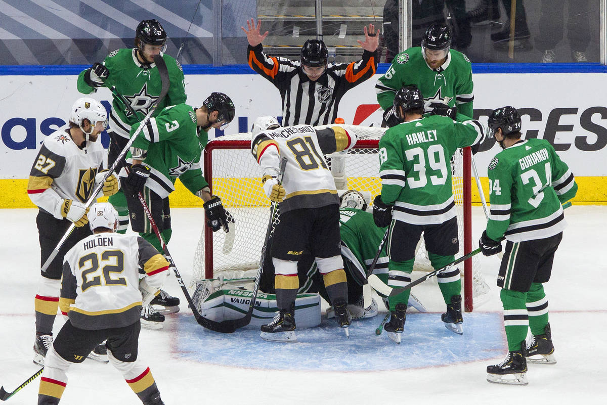 The referee calls a no goal as Dallas Stars and Vegas Golden Knights players look toward the ne ...
