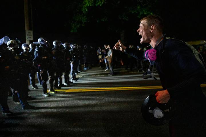 A protester screams at police as as Portland protests continue reaching 100 consecutive nights ...