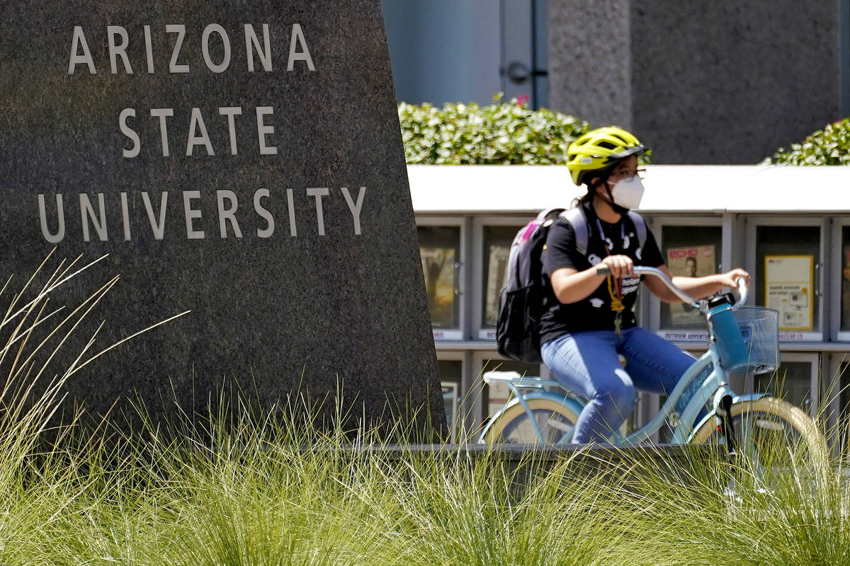FILE--A cyclist crosses an intersection on the campus of Arizona State University on Tuesday, S ...