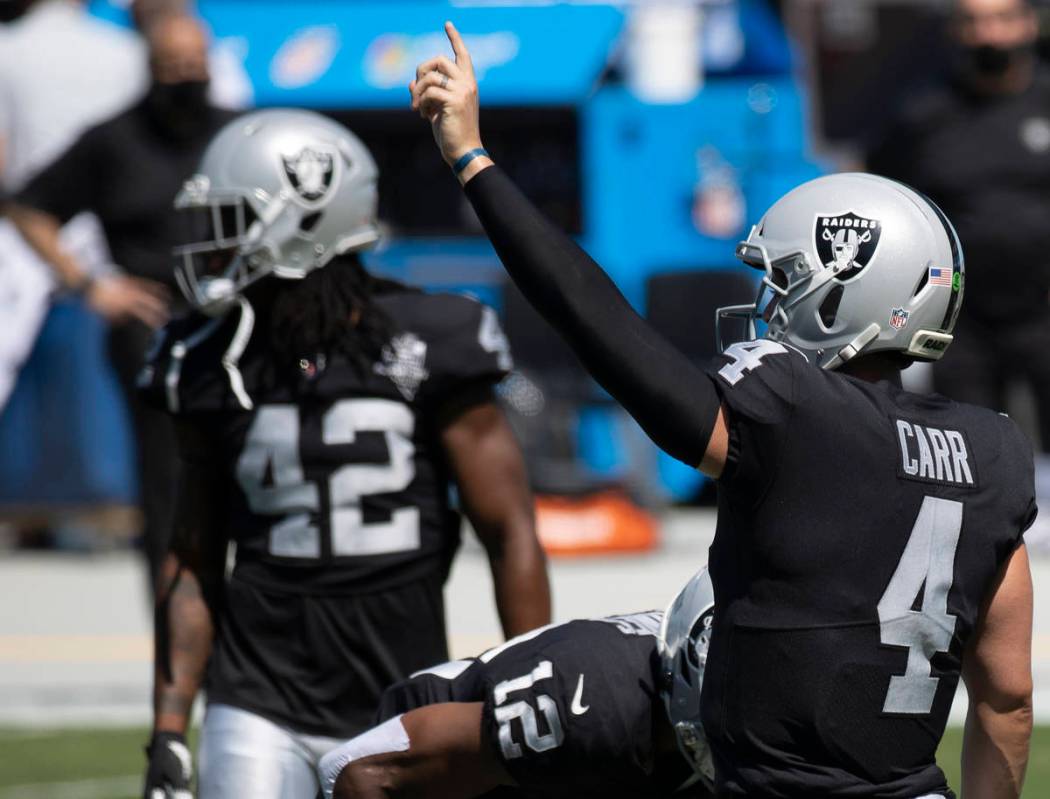 Las Vegas Raiders quarterback Derek Carr (4) warms up before the start of an NFL football game ...