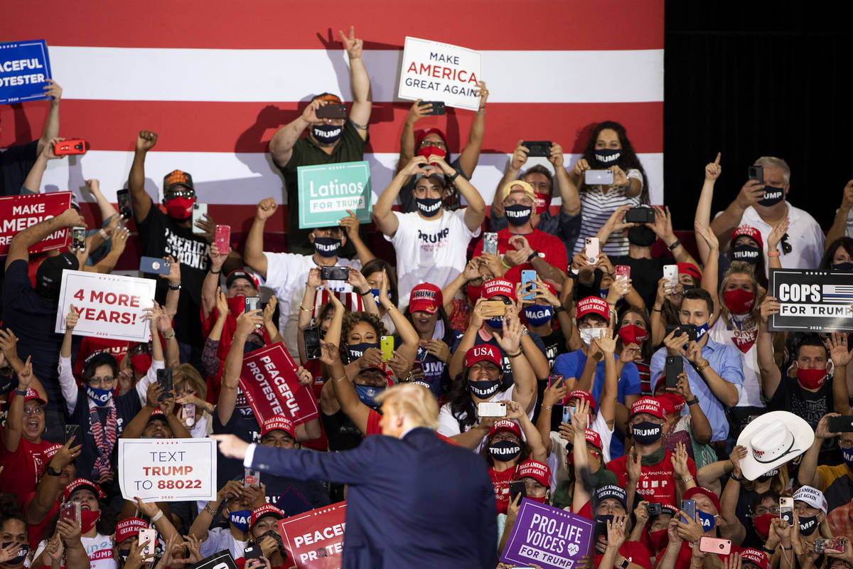 President Donald Trump waves and points while leaving the stage after speaking at a campaign ra ...