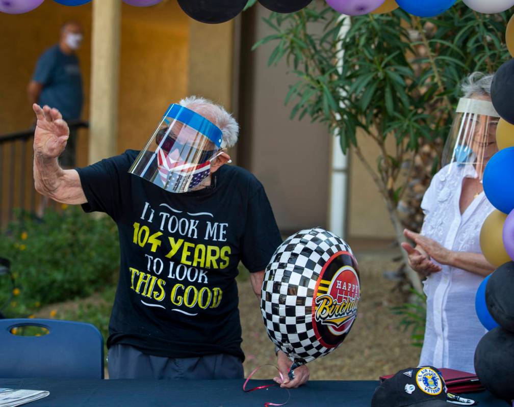 Vincent Shank, a World War II veteran and ex-POW turns 104 today, waves to car parade participa ...