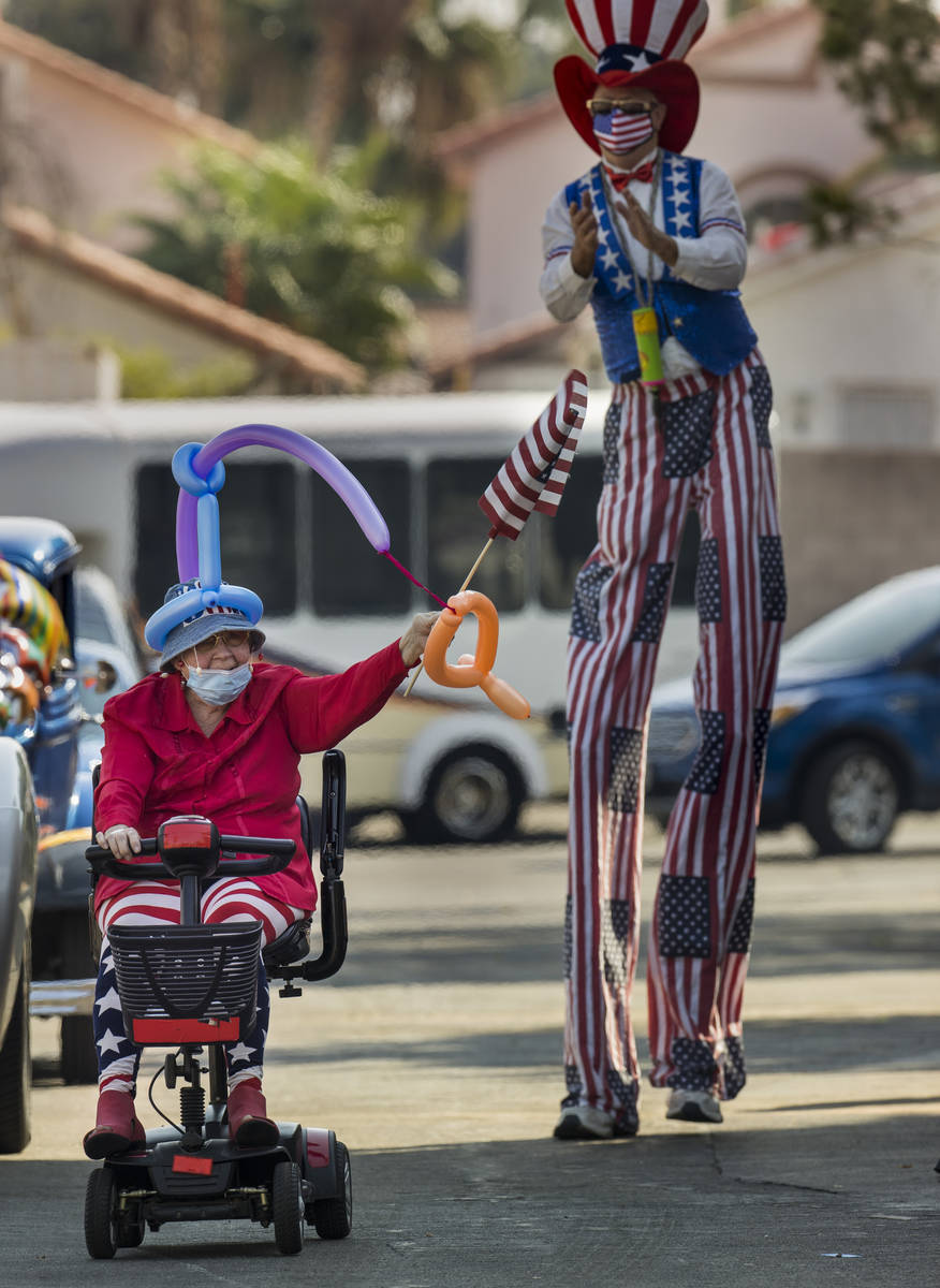 Car parade participant Carolyn Katz waves a flag during the celebration for Vincent Shank, a Wo ...