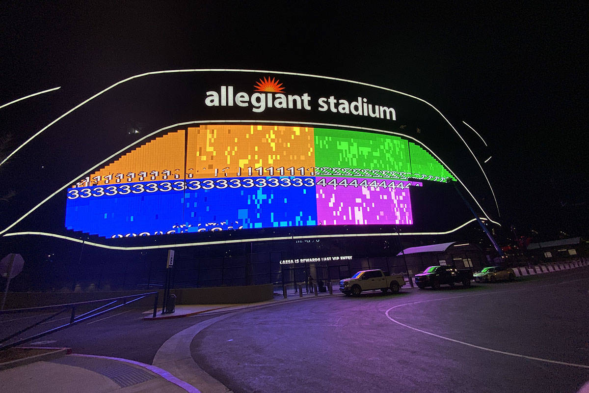 The massive video board lit up on the Interstate 15 facing portion of Allegiant Stadium. (Mick ...