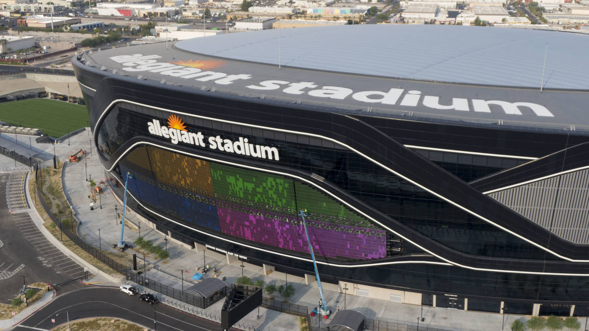 The massive 27,600-square-foot video board lights up with color on side of Allegiant Stadium th ...